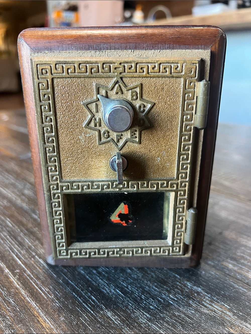 Vintage wood coin bank featuring an authentic post office door. 1958
6” by 4.5”